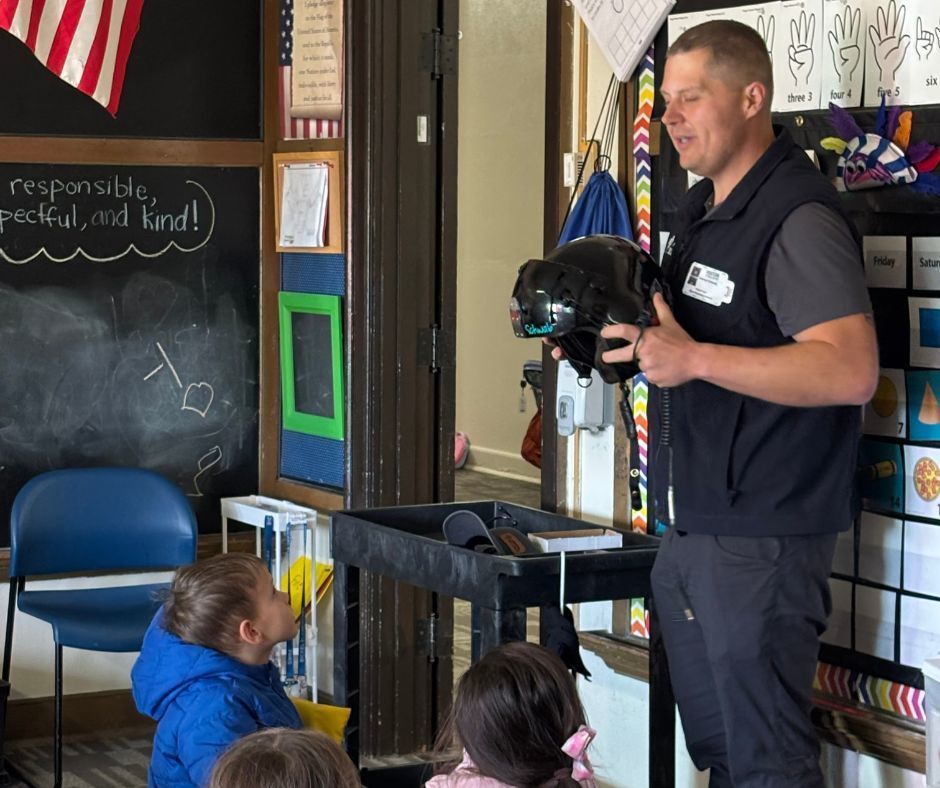 Helicopter paramedic demonstrating his helmet to the students