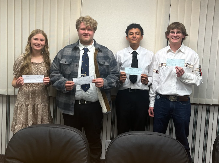 Students pose for a picture with prize money.