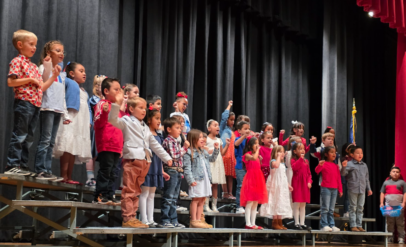 Students sing in red white and blue clothing.