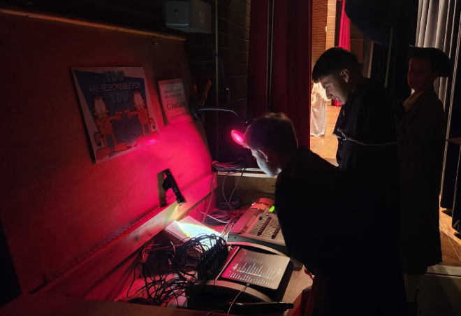 Cast members work the light board during the production of the Legend of Sleepy Hollow at OMS