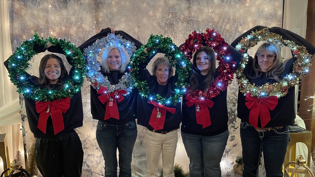 TFHS kitchen crew dressed up like holiday wreaths. 