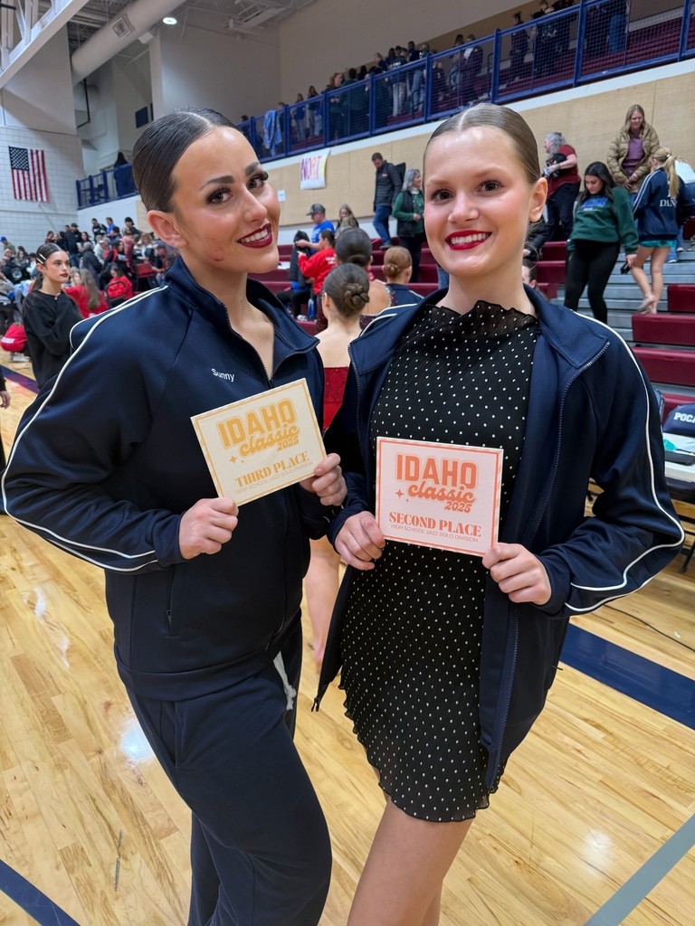 A couple of female dancers stand holding their Idaho Classic second and third place certificates