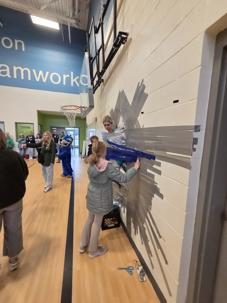 Child, taping principal to the wall