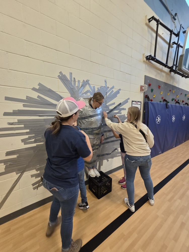 Child, taping principal to the wall
