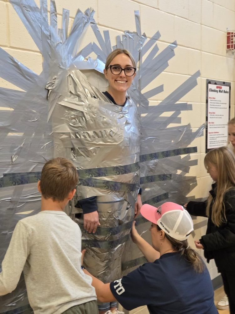 Child, taping principal to the wall