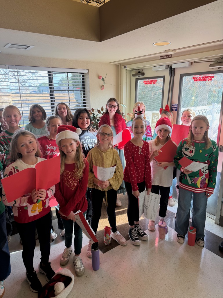Students with song books in and entryway.