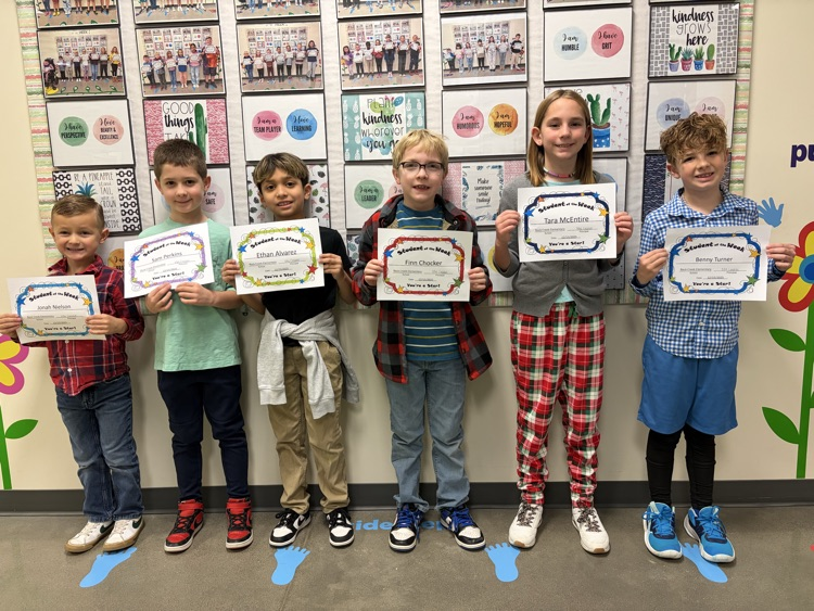 students of the week holding a certificate
