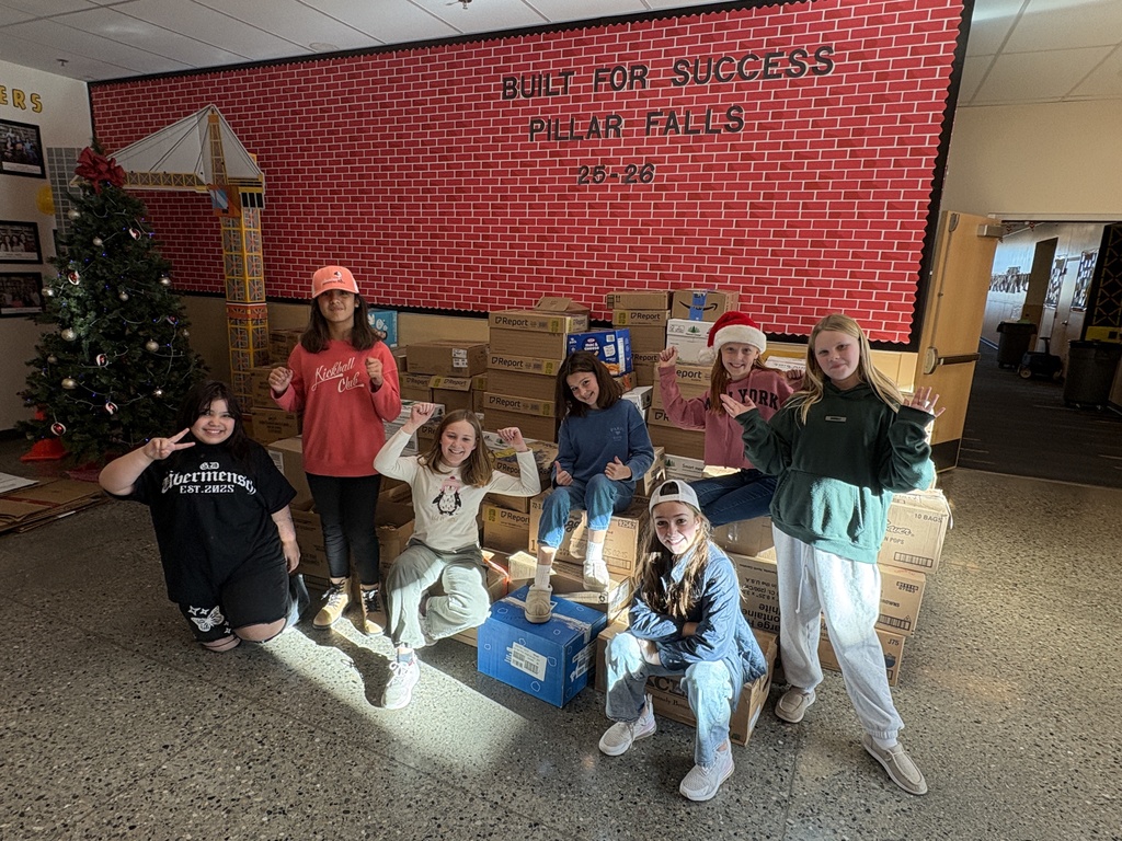 students sitting in front of donated food items