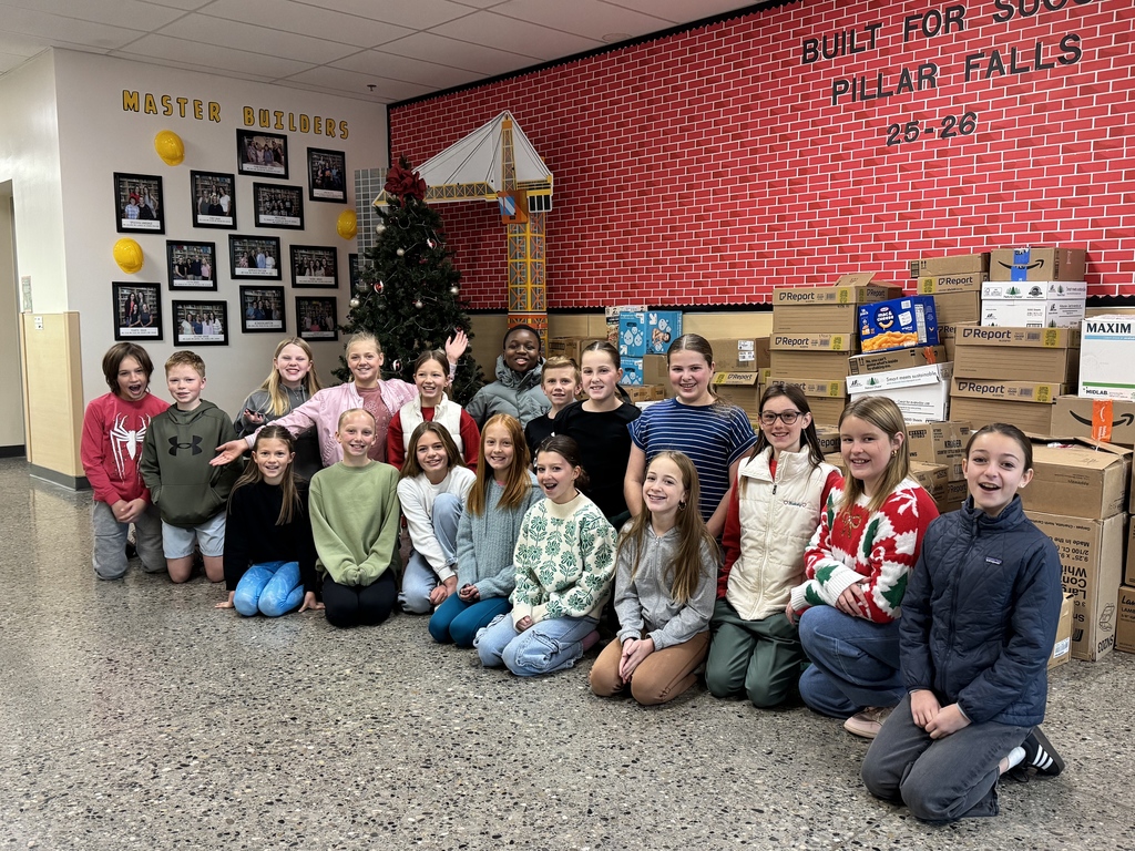 students sitting in front of donated food items