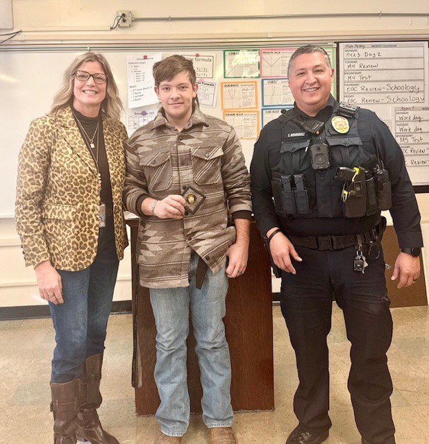 SRO, Male Student, and Principal standing with Challenge Coin