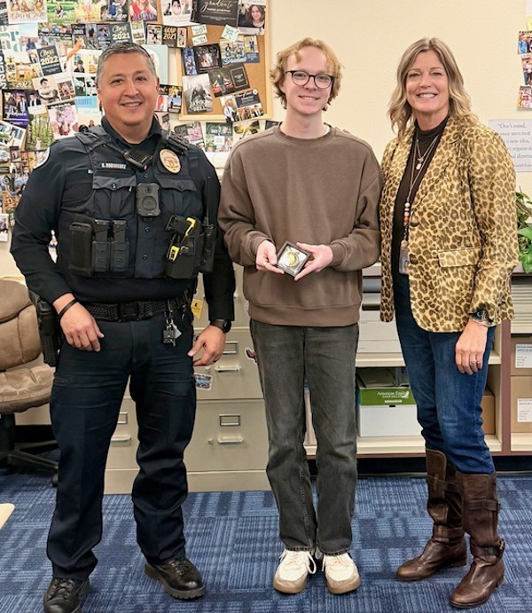 SRO, Male Student, and Principal standing with Challenge Coin