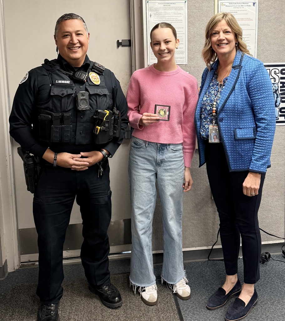 SRO,  Female Student, and Principal standing with Challenge Coin