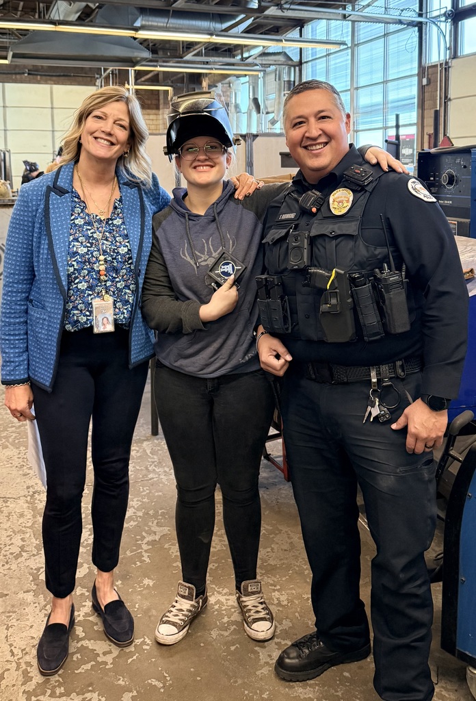 SRO, Female Student, and Principal standing with Challenge Coin