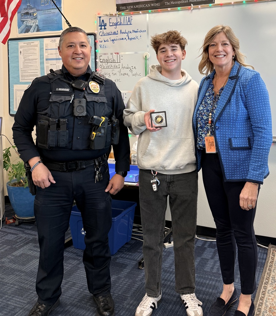SRO, Male Student, and Principal standing with Challenge Coin