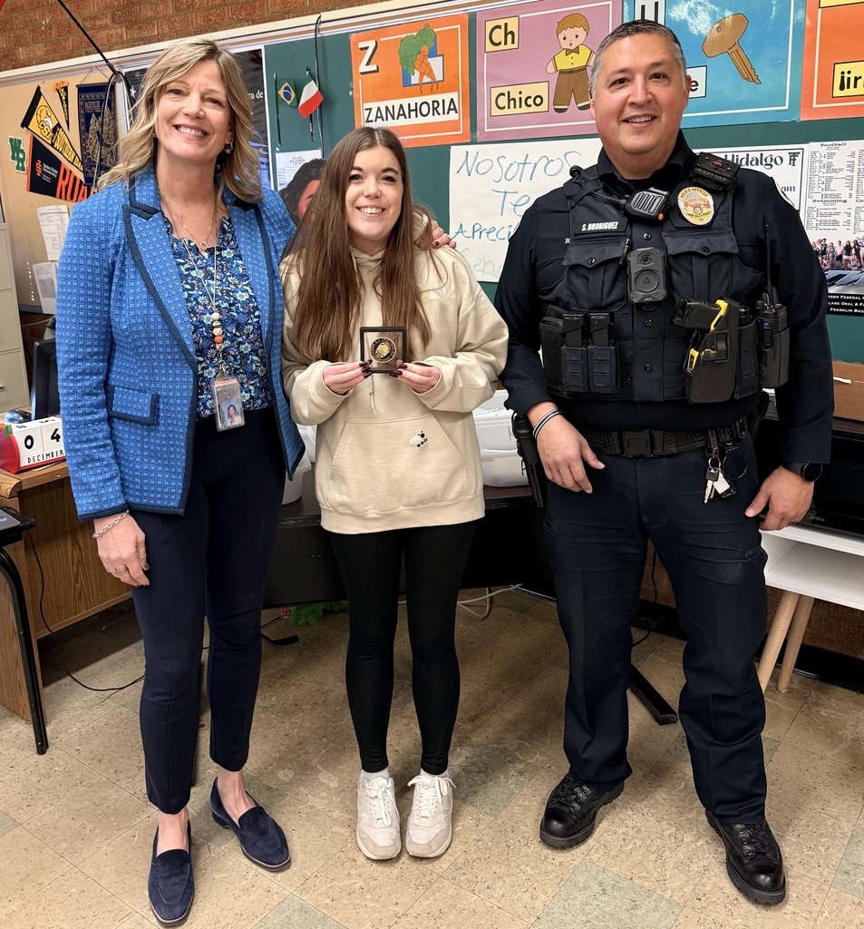 SRO,  Female Student, and Principal standing with Challenge Coin