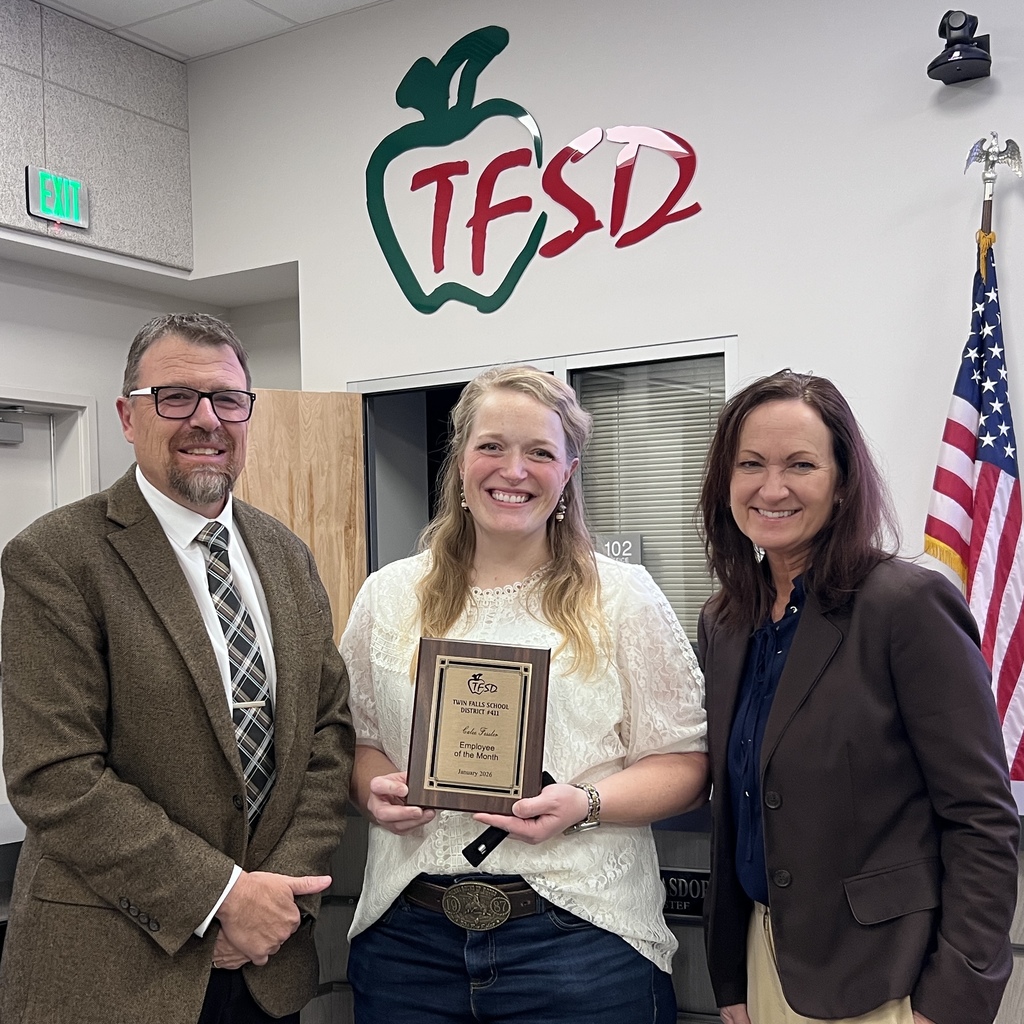 Employee of the Month pictured with superintendent and board member.