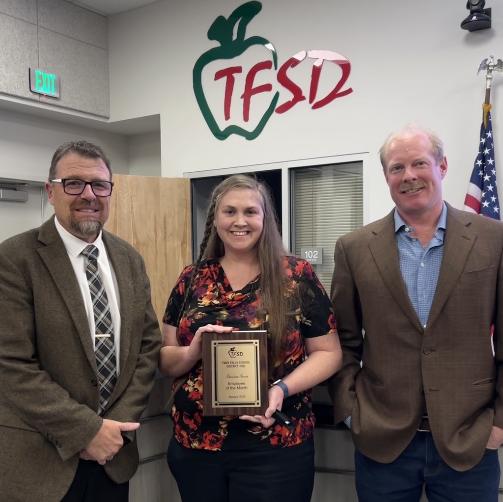 Employee of the Month pictured with superintendent and board member.