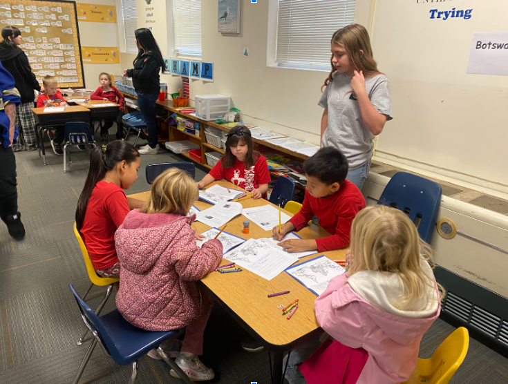 Students at a table writing