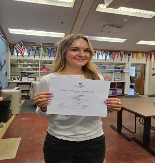 Student holding certificate
