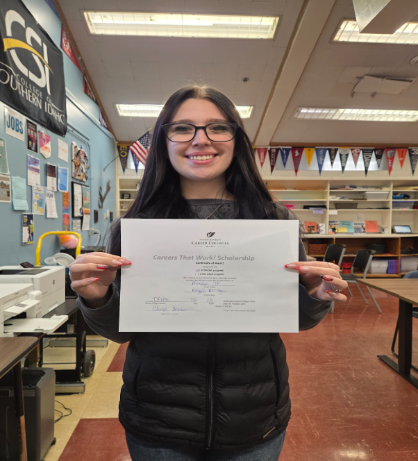 Student holding certificate