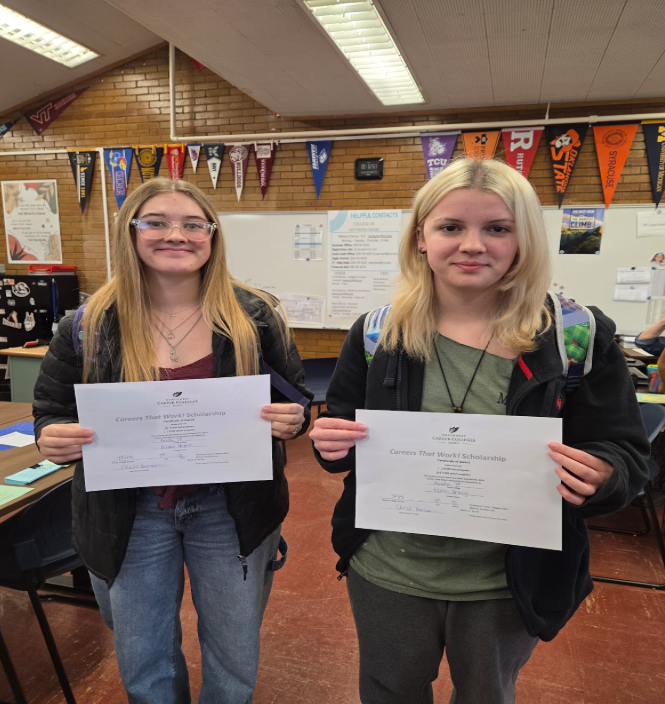 Two students holding certificate