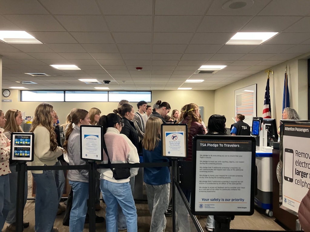 Students in TSA queue while being spoken to.