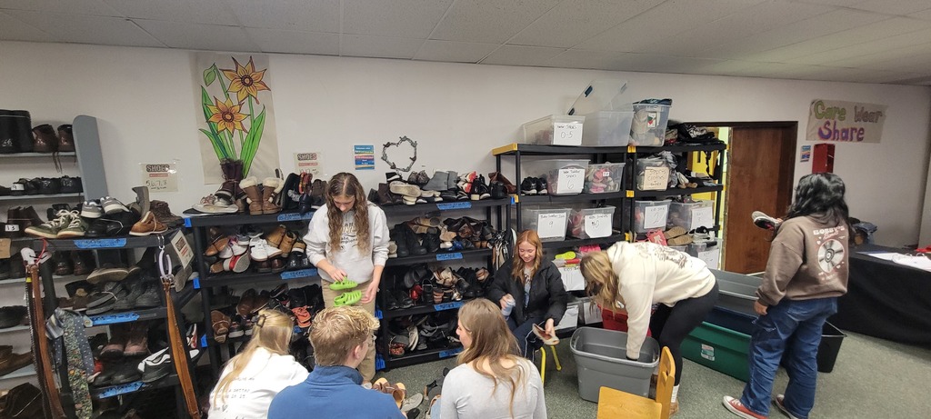 Students helping organize shoes donations