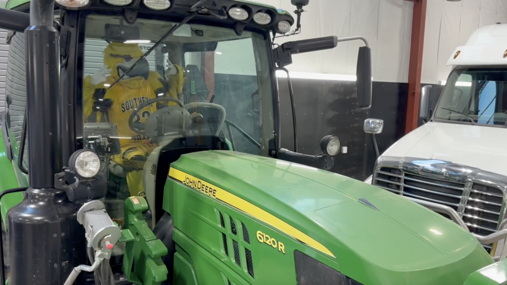Gilbert, CSI's Golden Eagle Mascot, sitting inside a tractor