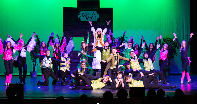 Large group of students posed on stage