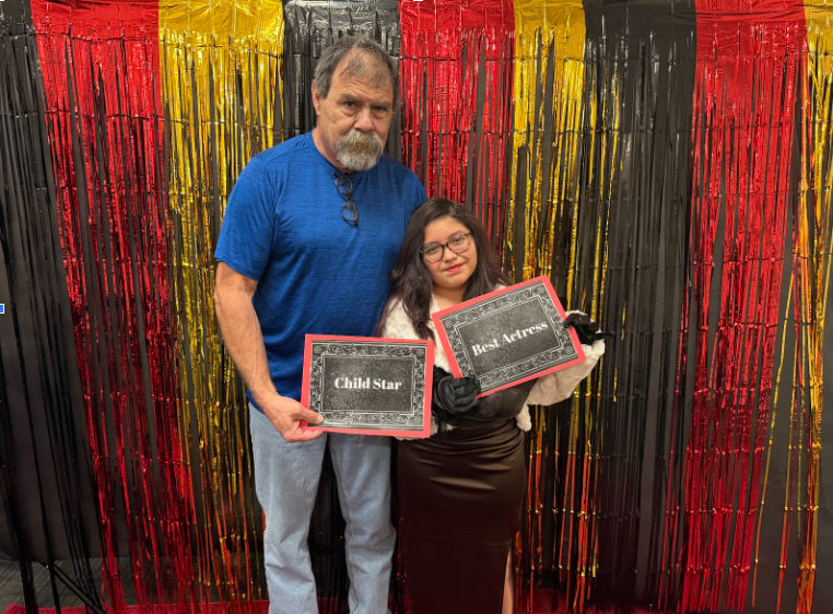 A parent or grandparent posed with student.