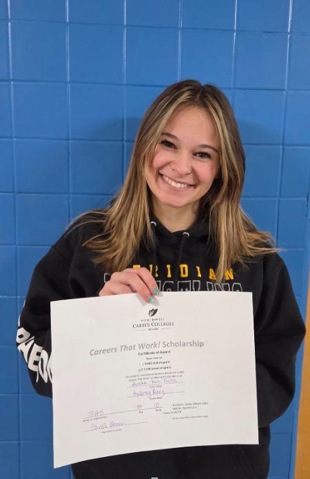 Student showing a certificate