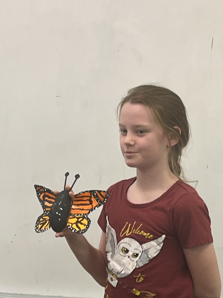 Student showing a decorated potato