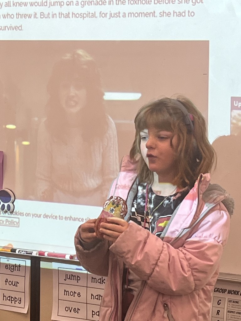 Student showing a decorated potato