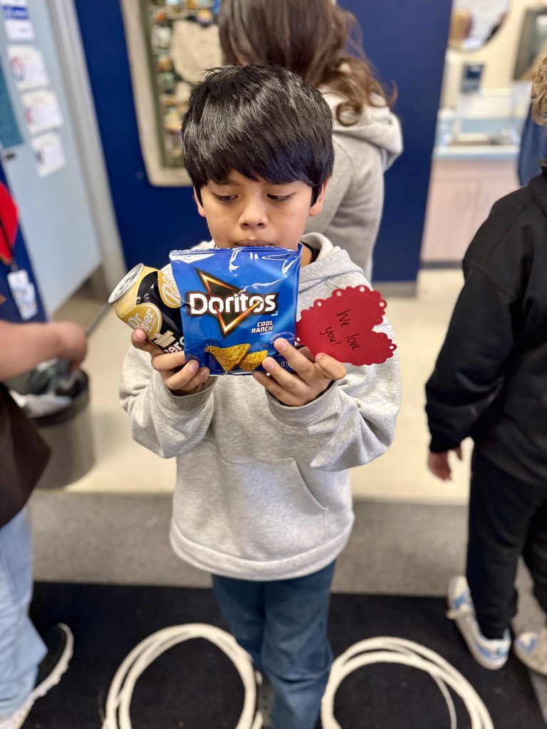 Student smiling before gifting treats to counselor