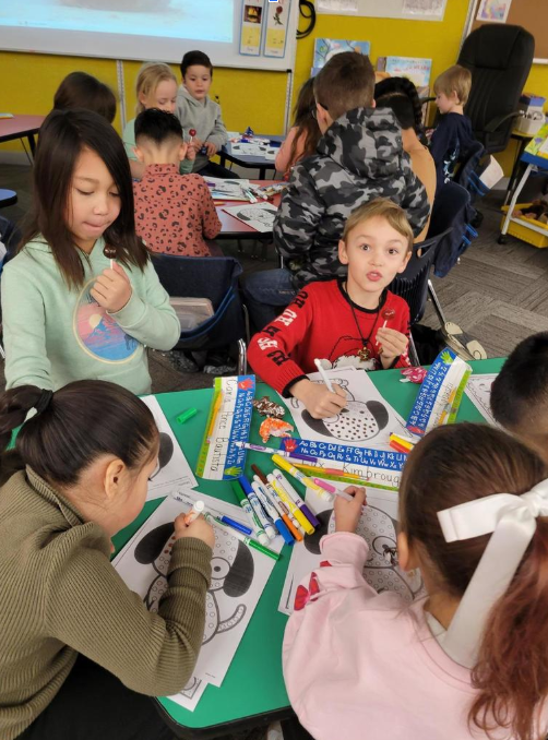 Students at table coloring