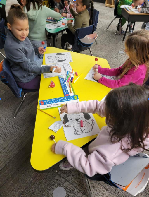 Students at a table coloring