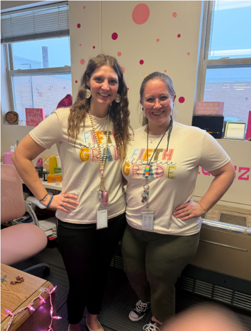Two staff members dressed in matching t-shirts for "Twin Day"
