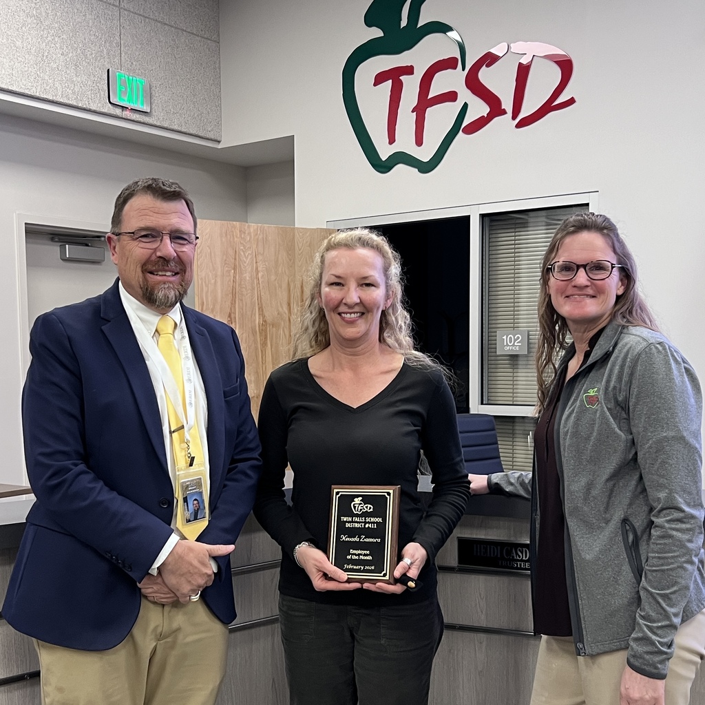 School employee holding plaque standing with school board member