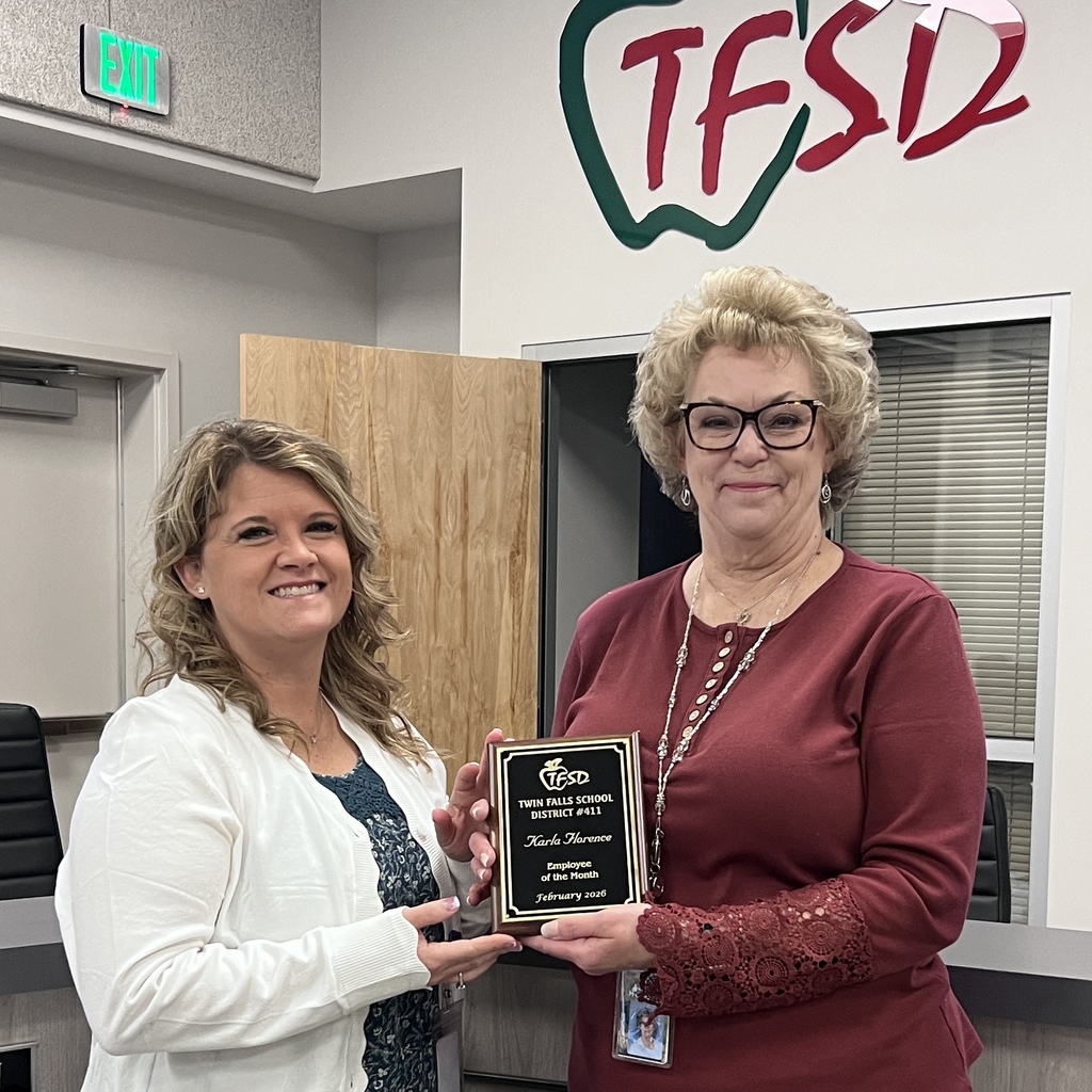 School employee holding plaque standing with school administrator
