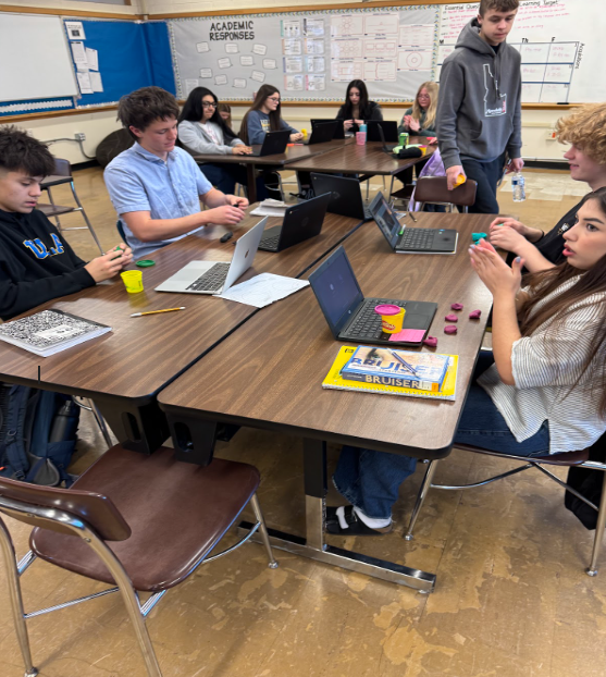 Students at their desks sculpting playdoh