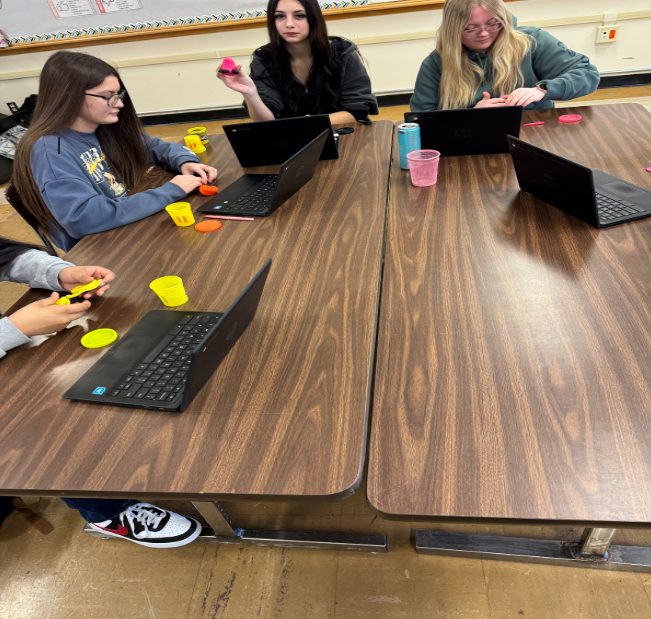 Students at their desks sculpting playdoh