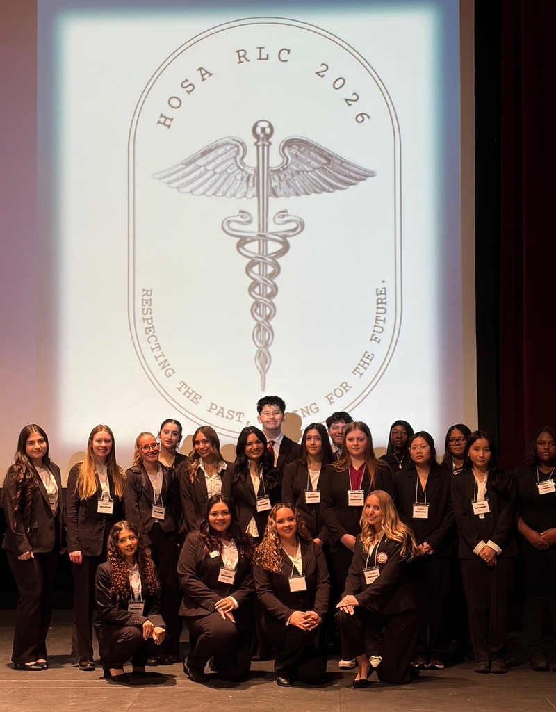Students pictured in front of "HOSA RLC 2026" back drop