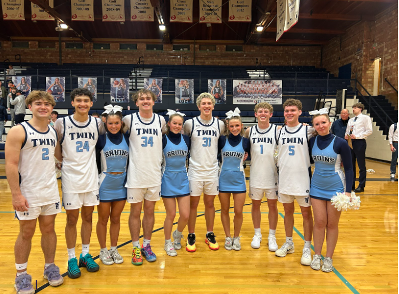 Basketball players and cheerleaders pictured in the middle of the basketball court
