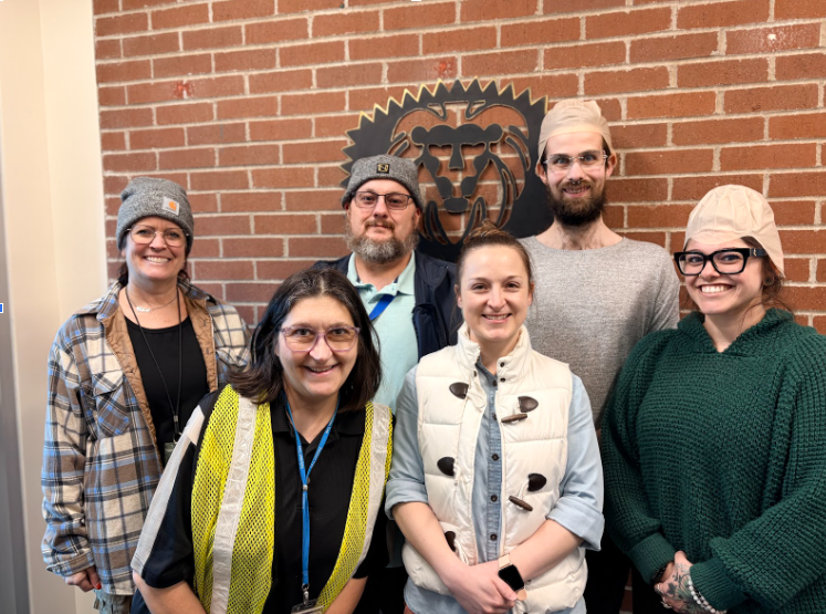 Staff members dressed up in beanies or bald caps to imitate the school counselor.