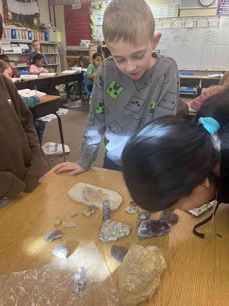 Using a magnifying glass to observe a rock