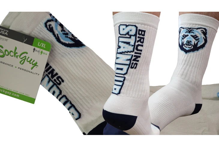 White socks with Bruins Stand Up along the back and a bruin head on the front.