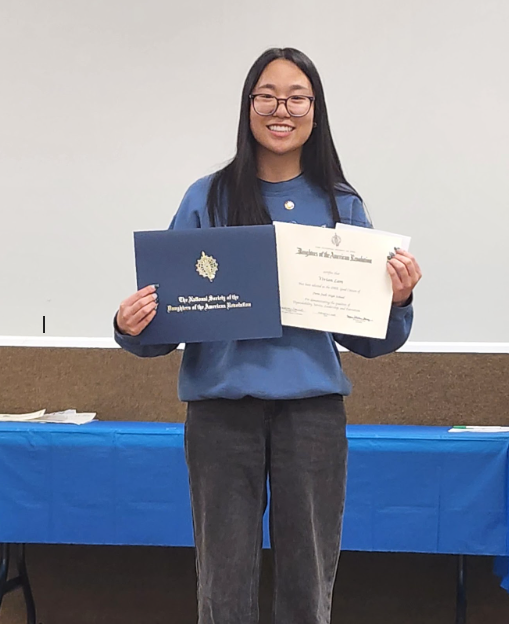 Student holding certificate