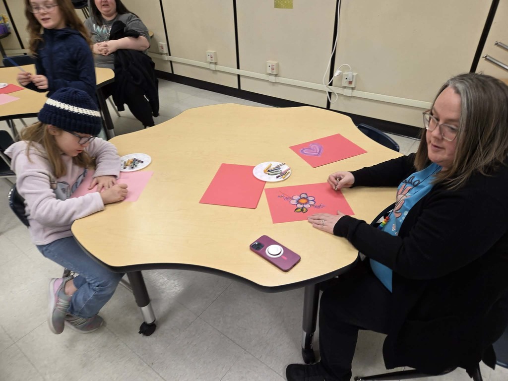 Mrs. Barrow and student makes art.