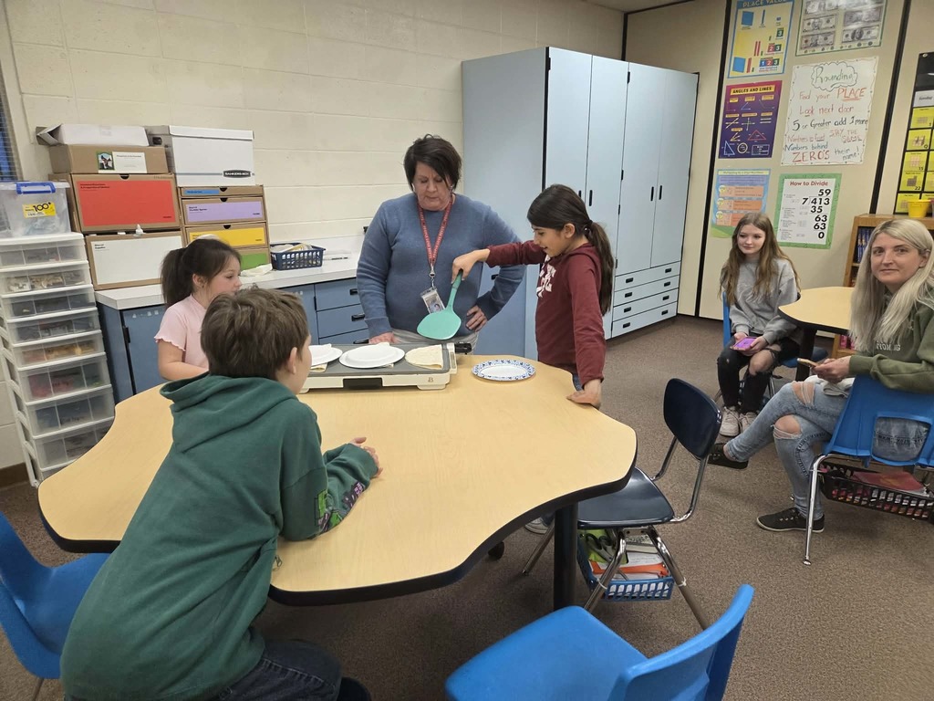 Mrs. Bronson helping students make quesadillas