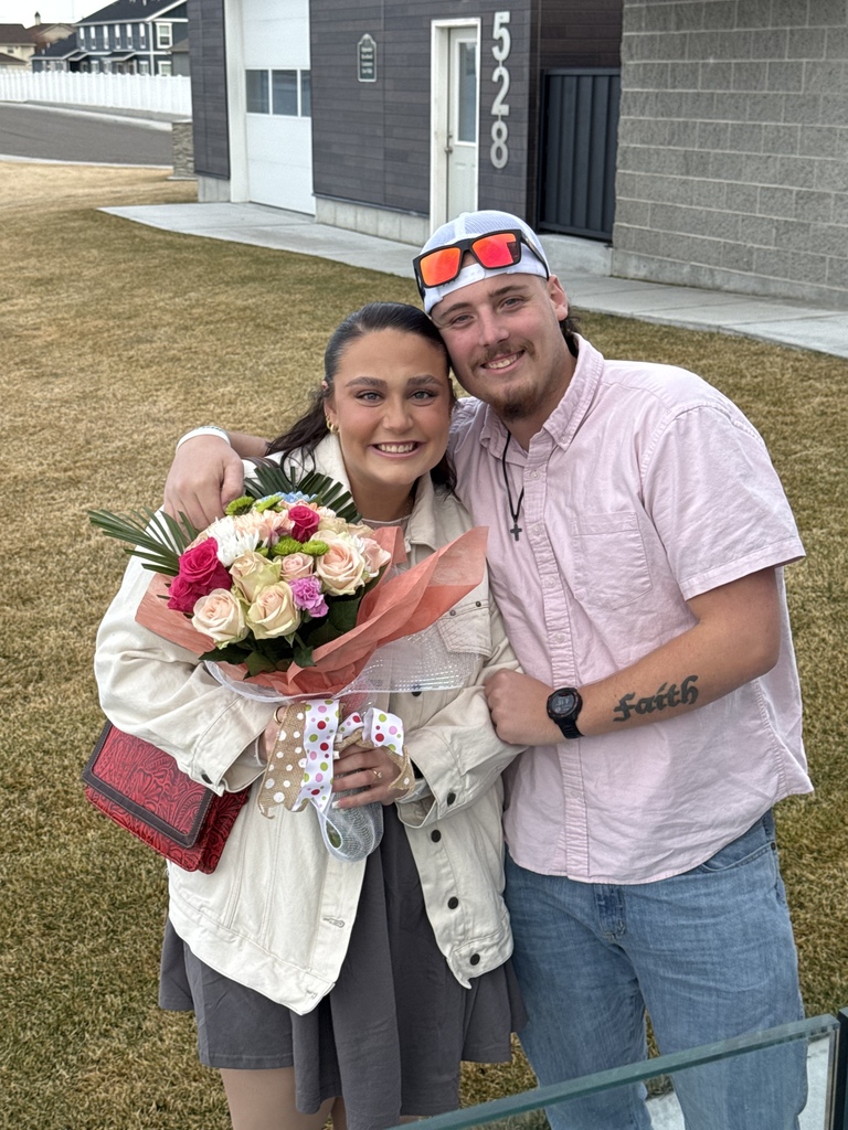 A couple very enthusiastically smiling for a picture after the proposal
